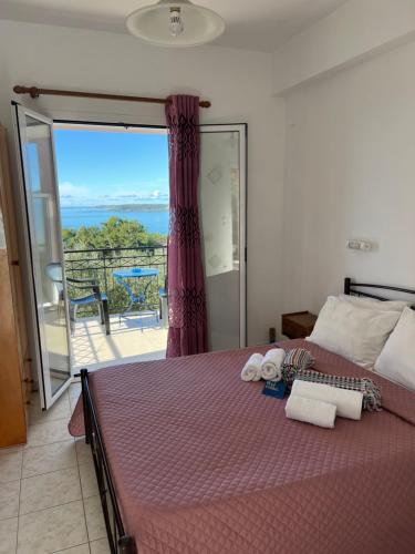 a bedroom with a bed with a view of the ocean at Alexandra’s Studios Sunset View in Argostoli