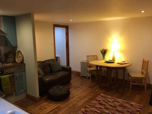 a living room with a couch and a table at The Quirky, cosy hideaway! An apartment close to Leeds City Centre in Amley