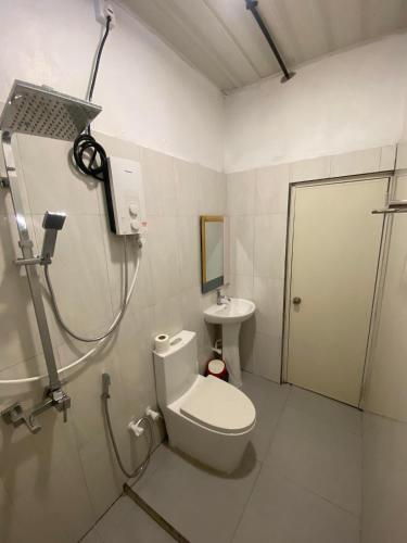 a bathroom with a shower and a toilet and a sink at Rashuthere Maldives in Rasdu