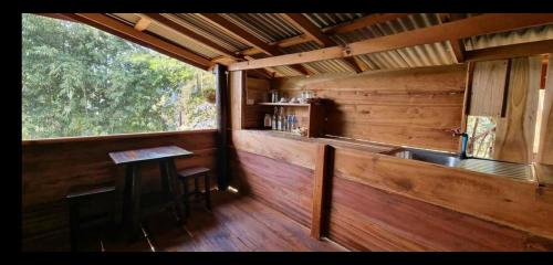 a kitchen in a cabin with a sink and a counter at PeaMoo Homestay in Chom Thong