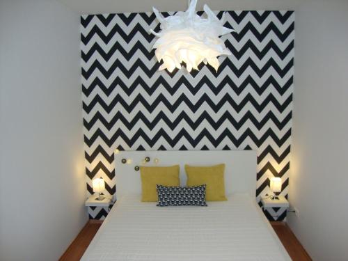 A bed or beds in a room at Viktória Beach Apartman Gold 1. Siófok