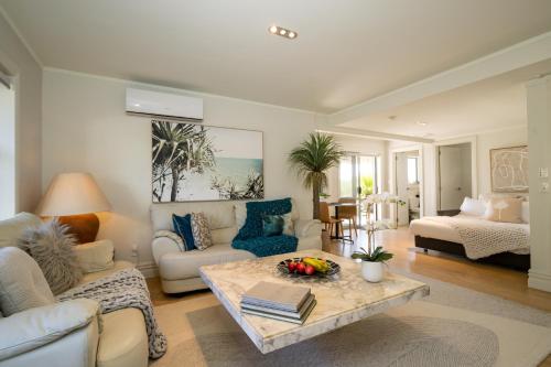 sala de estar con sofá y mesa en Absolute Beach, en Mount Maunganui