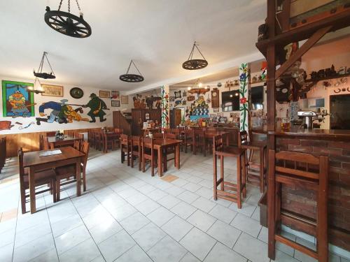 a dining room with wooden tables and chairs at Hrusická restaurace a penzion in Hrusice
