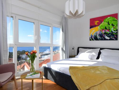 a bedroom with a bed and a large window at CLOUD APARTMENTS DUBROVNIK in Dubrovnik