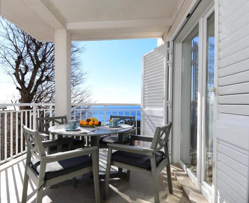 a porch with a table and chairs on a balcony at CLOUD APARTMENTS DUBROVNIK in Dubrovnik