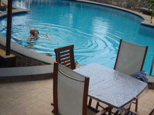 a woman swimming in a swimming pool at Hotel Al Togo Fitness & Relax in Vulcano