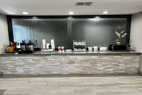 a counter in a restaurant with a brick wall at Super 8 by Wyndham Sealy in Sealy
