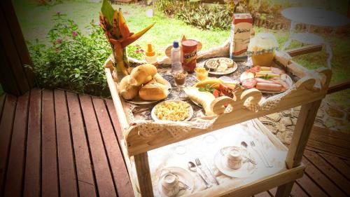 a picnic table with food and drinks on it at Home suíte taipu in Marau