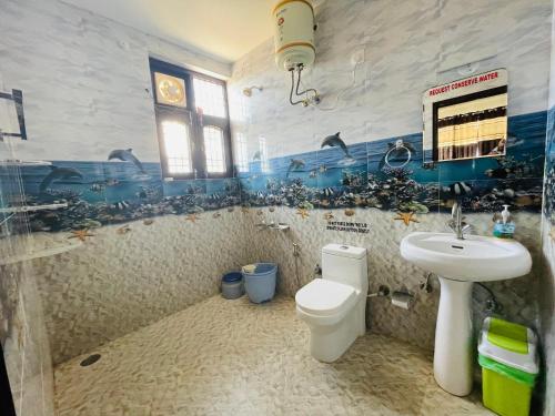 a bathroom with a sink and a toilet in it at Himalayan Retreat in Pālampur