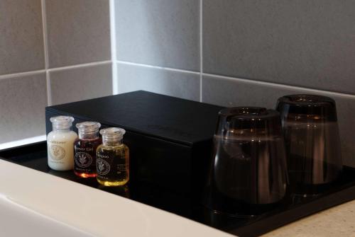 a counter with two bottles of honey and a coffee maker at Ramada Encore by Wyndham CheonAn in Cheonan