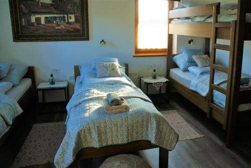 a bedroom with a bed with a teddy bear on it at Szentlőrincpuszta Major in Nyárlőrinc