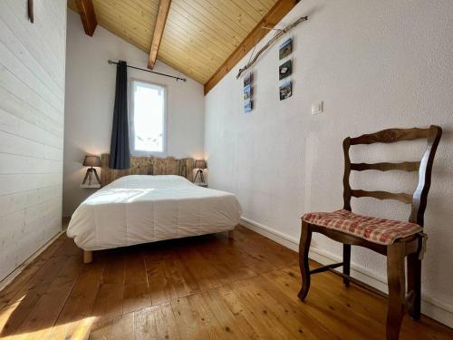 une chambre avec un lit, une chaise et une fenêtre dans l'établissement Maison rénovée près plage, 6 couchages, Saint-Pierre-d'Oléron - FR-1-246A-177, à Saint-Pierre-dʼOléron