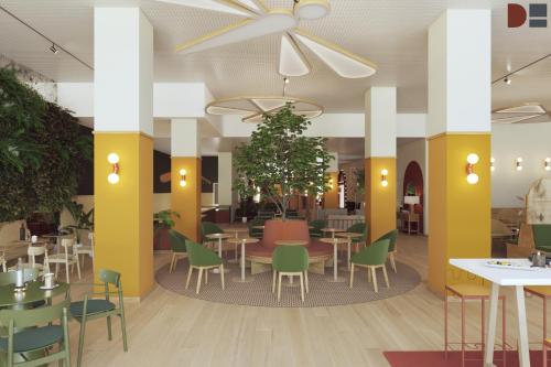 a restaurant with tables and chairs in a cafeteria at B&B HOTEL Geneva Airport in Geneva