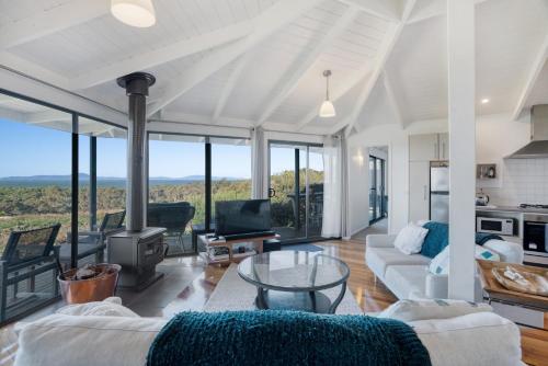 a living room with a couch and a glass table at Limosa Rise in Yanakie