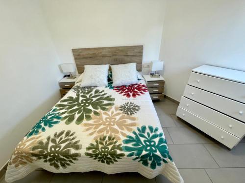 a bedroom with a bed and a dresser at Casa la Marinera in Binibeca
