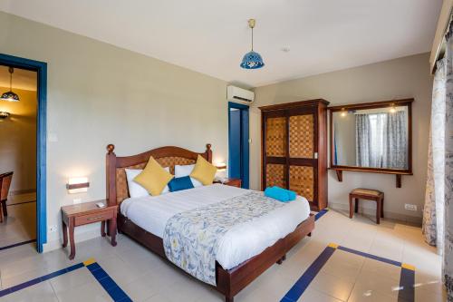 a bedroom with a large bed in a room at Le Grand Bleu Hotel in Trou aux Biches