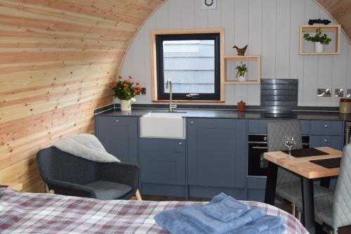 a kitchen with a sink and a table in a room at Oakwood Escapes in North Cliff