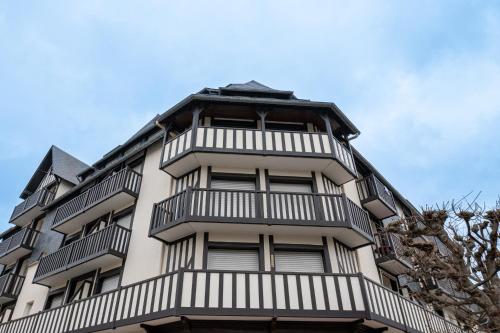 a tall building with balconies on top of it at Appartement deauville place Morny non fumeur in Deauville