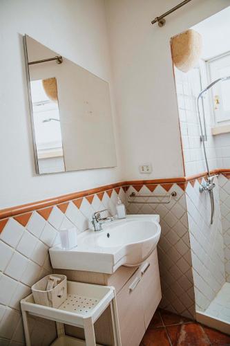 a bathroom with a sink and a mirror at Dimora Santangelo in Lecce