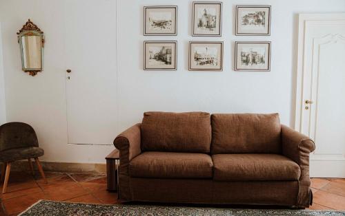 a living room with a couch and pictures on the wall at Dimora Santangelo in Lecce
