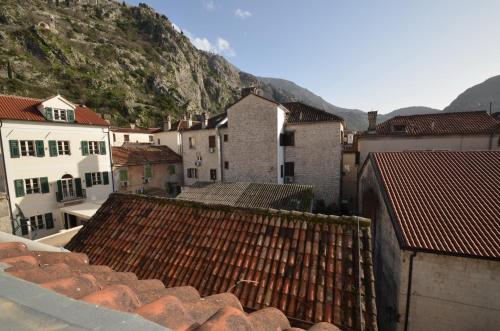 a view of a city with buildings and mountains at Old town central in Kotor