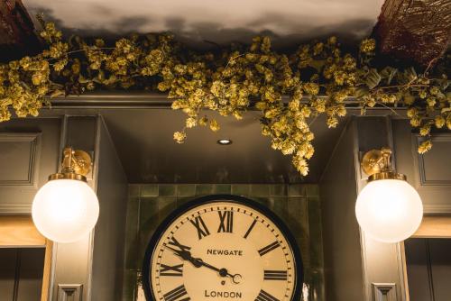 a clock in a room with lights and flowers at The Kings Arms Hotel in Keswick