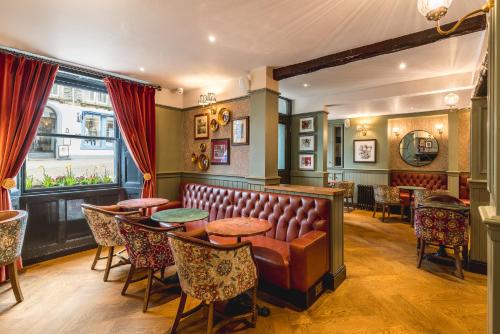a pub with a bench and tables and chairs at The Kings Arms Hotel in Keswick