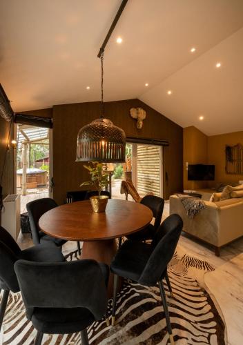 a dining room with a table and chairs at ZEN-Bungalow NO 4 met sauna en hottub in Rheezerveen