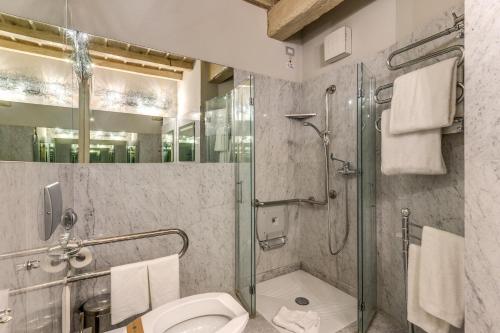a bathroom with a shower and a toilet at Hotel Santa Marta Suites in Milan