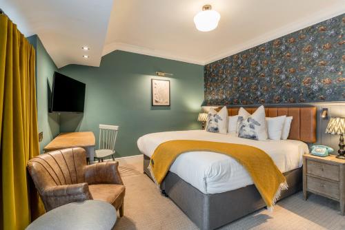 a hotel room with a bed and a tv at The Kings Arms Hotel in Keswick