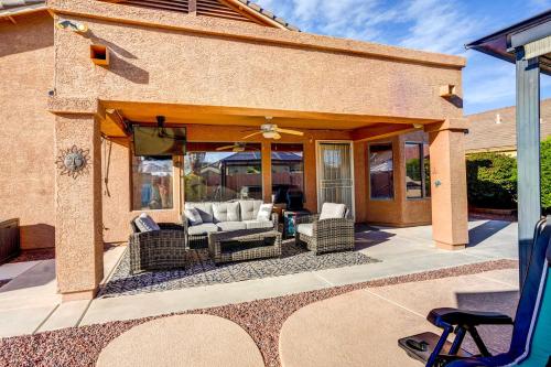 a patio with wicker chairs and an umbrella at Spacious Arizona Getaway with Pool, Pets Welcome! in Surprise