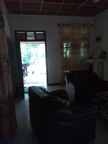 a living room with a couch and a sliding glass door at Southbank Homestay 