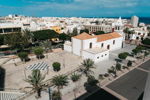 an aerial view of a city with a church at Sky Puerto in Puerto del Rosario