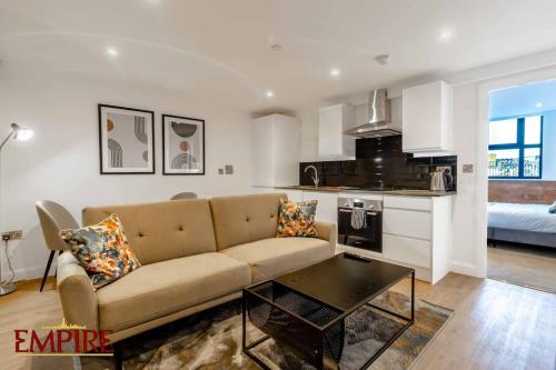a living room with a couch and a table at Brand New 1 Bed Apt Burton On Tr in Burton upon Trent
