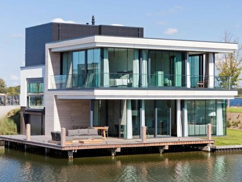 a house on a dock on the water at Waterfront holiday home in Arnemuiden in Arnemuiden