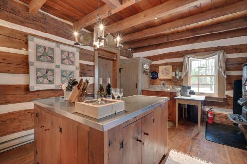 a kitchen with a large island in a log cabin at Cabin Vacation Rental about 8 Mi to Penn State! in State College
