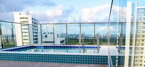 a swimming pool on top of a building at Home Boa Viagem in Recife