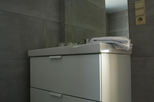 a bathroom with a white sink and a towel at Auberge du Carrefour Chez Odille in Vielsalm