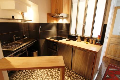a small kitchen with a counter and a sink at Love Nest In Paris in Paris