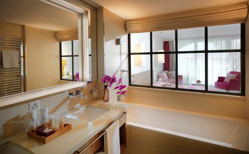 a bathroom with a sink and a large mirror at Giardino Ascona in Ascona
