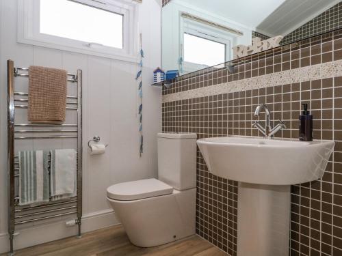 a bathroom with a toilet and a sink at Amberwood 42 in Lymington