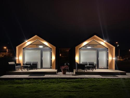 a house with two gazebos at night at Domki Przy Brzegu Chłapowo in Władysławowo