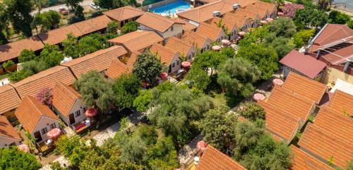 an overhead view of a row of houses with trees at Clover Magic Nova Beach Hotel in Side