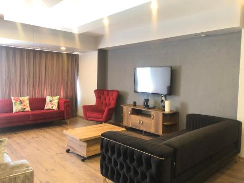 a living room with a couch and a flat screen tv at Alsama Apart No 149 in Istanbul