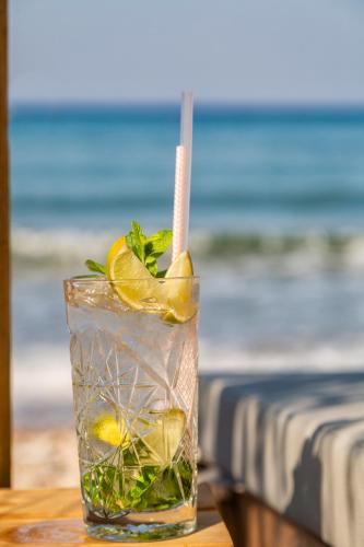 a drink with lemon and mint on a table at Erato by Samian Mare in Karlovasi