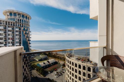 a view of the ocean from a balcony of a building at Hotel 19 Batumi in Batumi
