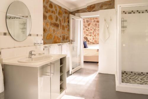 a white bathroom with a sink and a mirror at Trout Escape Farm in Dullstroom