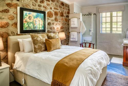 a bedroom with a large bed with pillows on it at Trout Escape Farm in Dullstroom