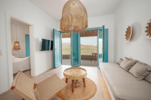 a living room with a couch and a table at Anemela Villas & Suites Mykonos in Agrari