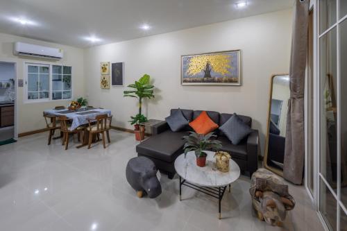 a living room with a couch and a table at 46 Golden House in Chiang Mai
